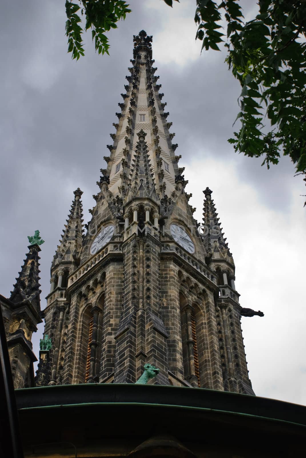 Dark medieval church in city centre of Leipzig against clouds