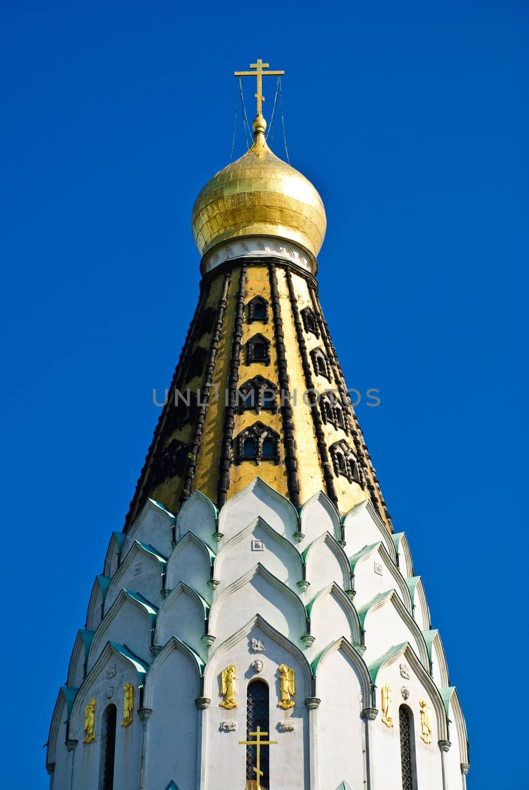 Gold domes of a temple white sparkle on the sun