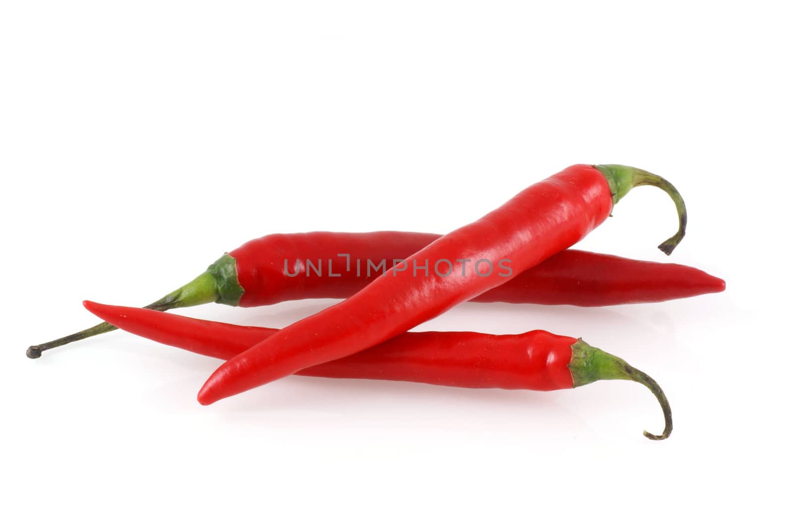 Three red peppers isolated on a white background.