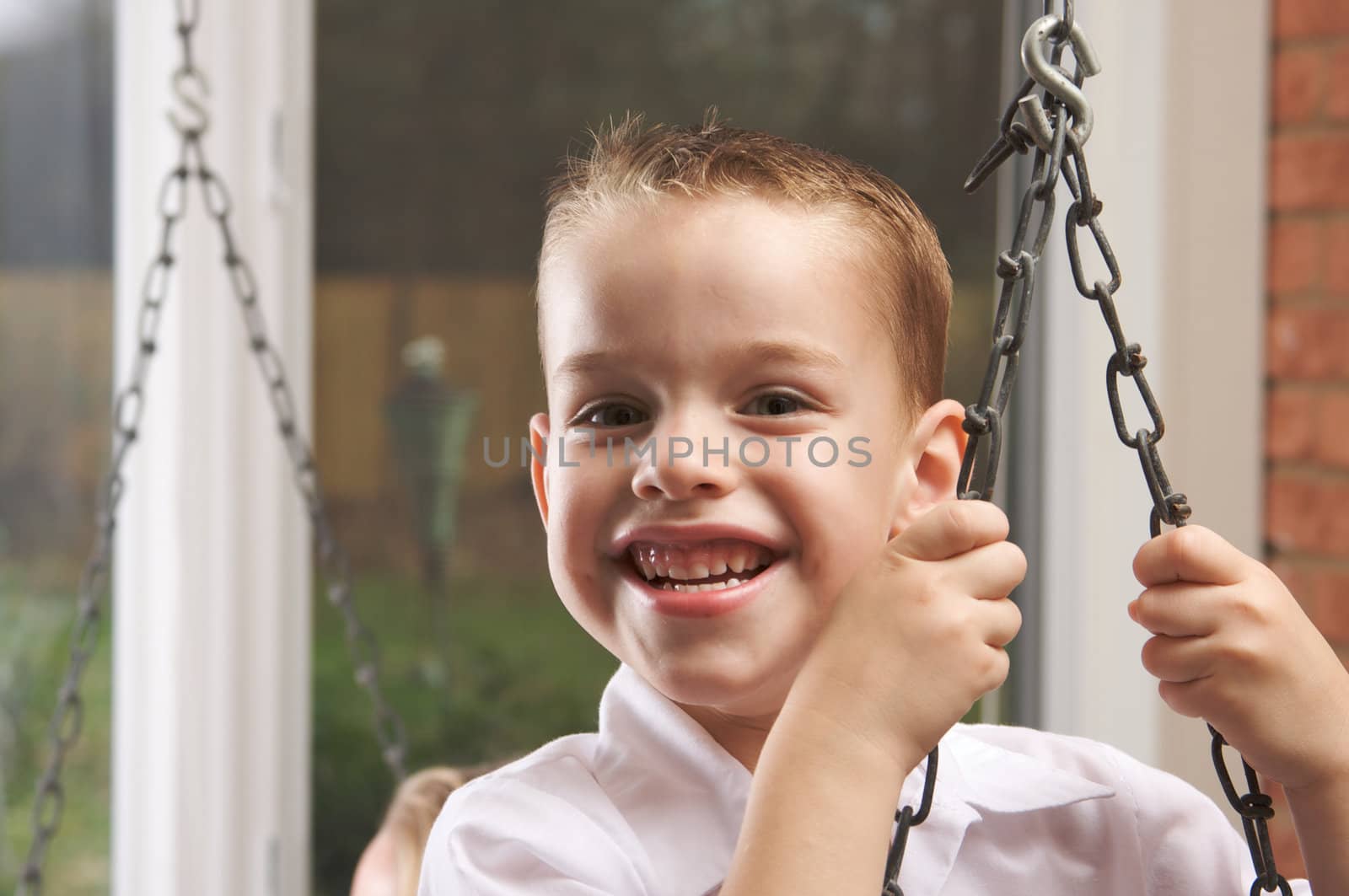 Adorable Young Boy with Blue Eyes Smiles for the Camera