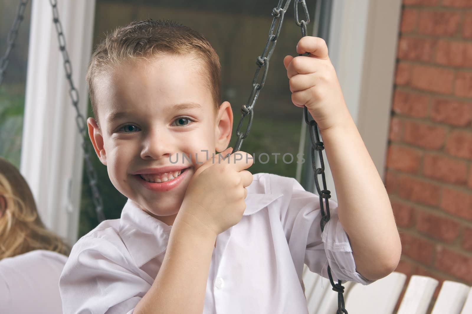 Adorable Young Boy with Blue Eyes Smiles for the Camera