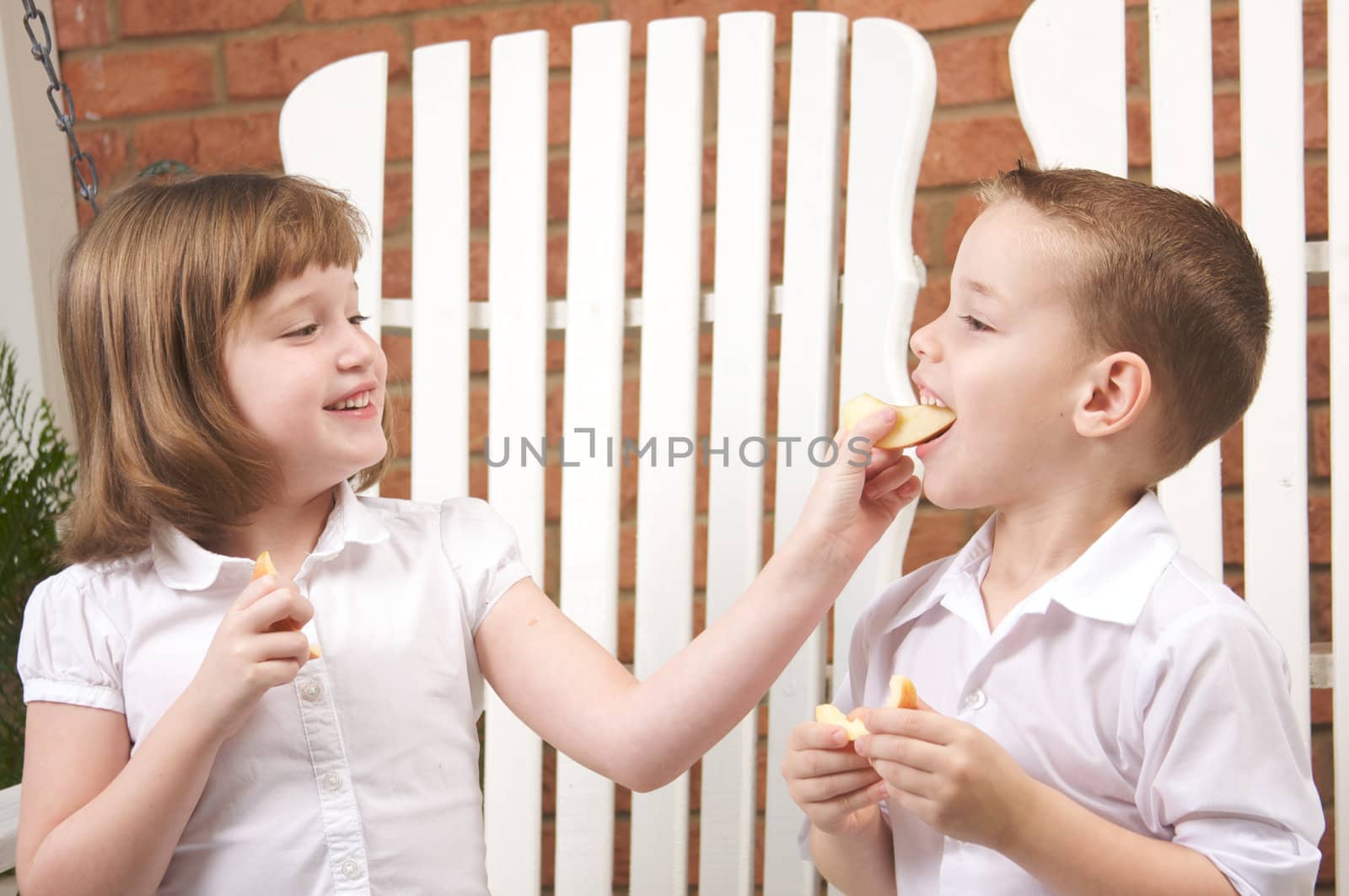 Sister and Brother Having Fun Eating an Apple