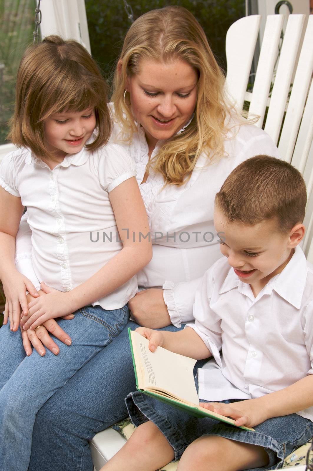 Young Boy Reads to His Mother and Sister by Feverpitched