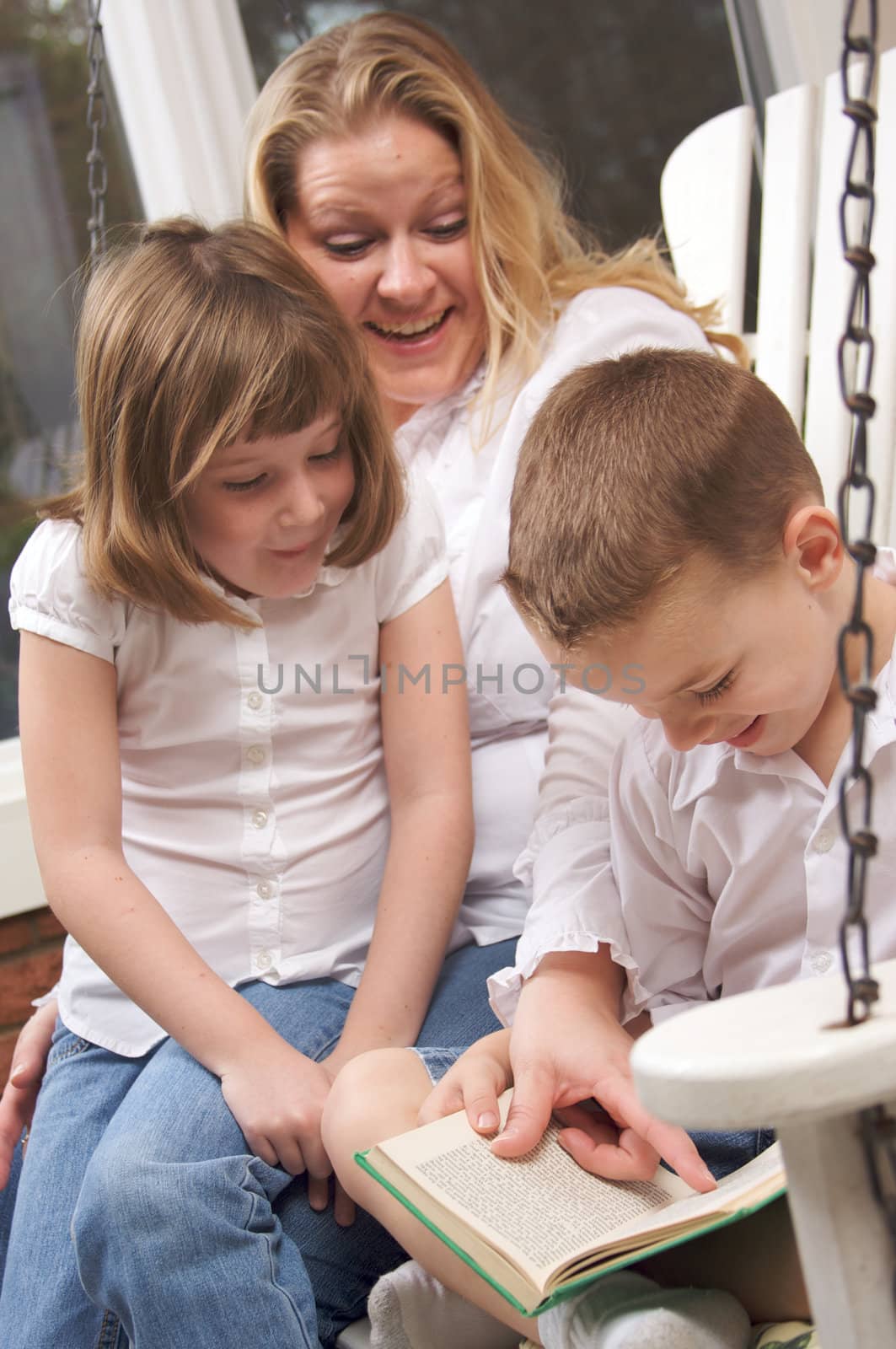 Young Boy Reads to His Mother and Sister by Feverpitched