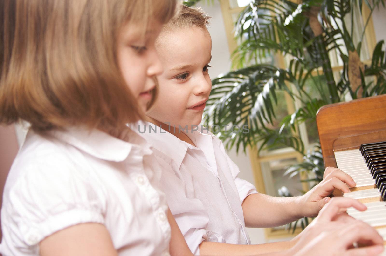 Brother and Sister Playing the Piano Together