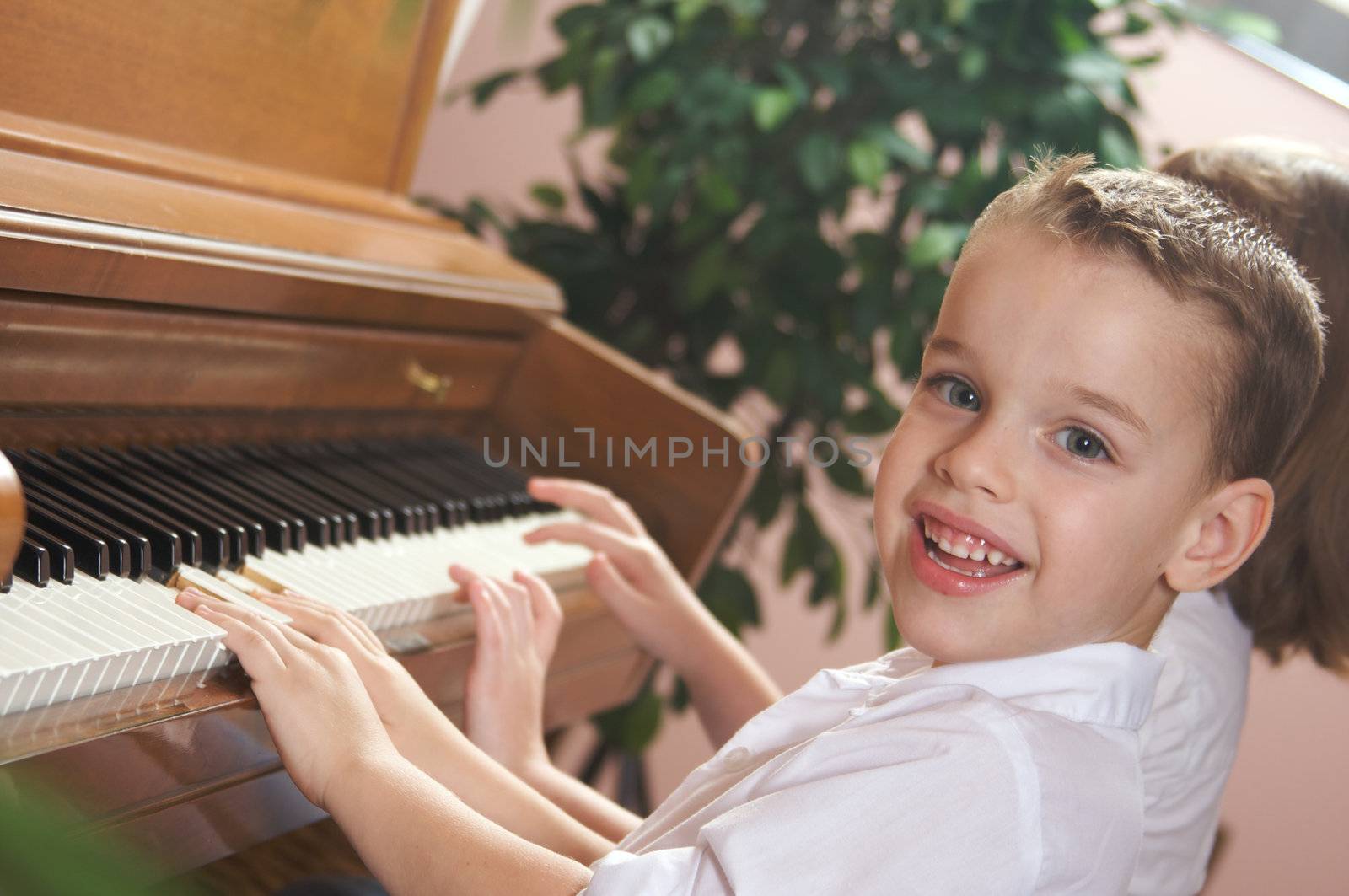 Brother and Sister Playing the Piano Together