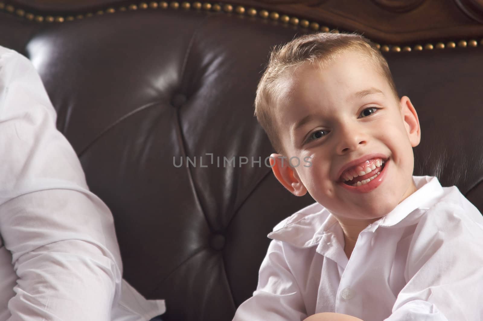 Adorable Young Boy with Blue Eyes Smiles for the Camera