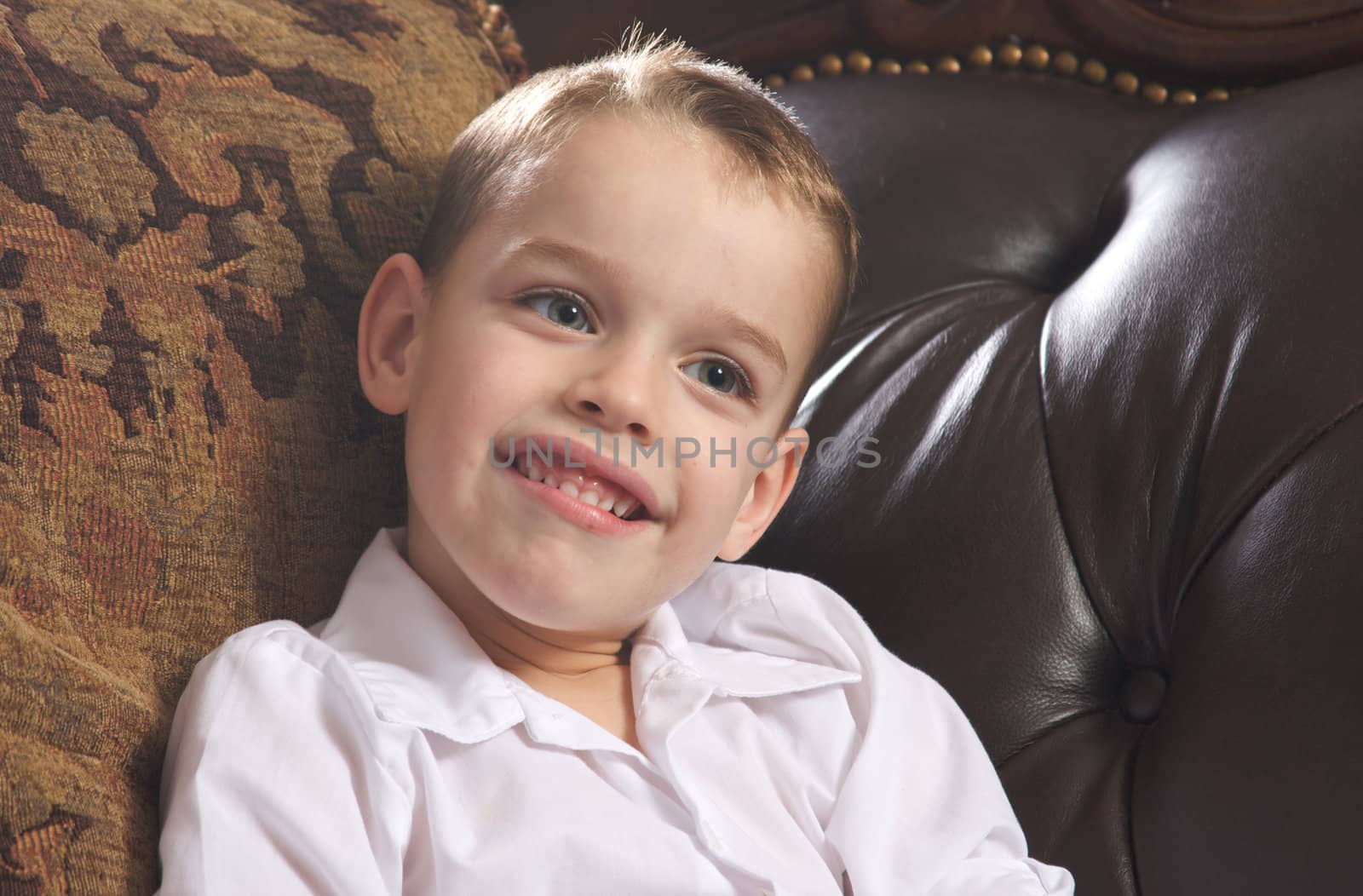 Adorable Young Boy with Blue Eyes Smiles for the Camera