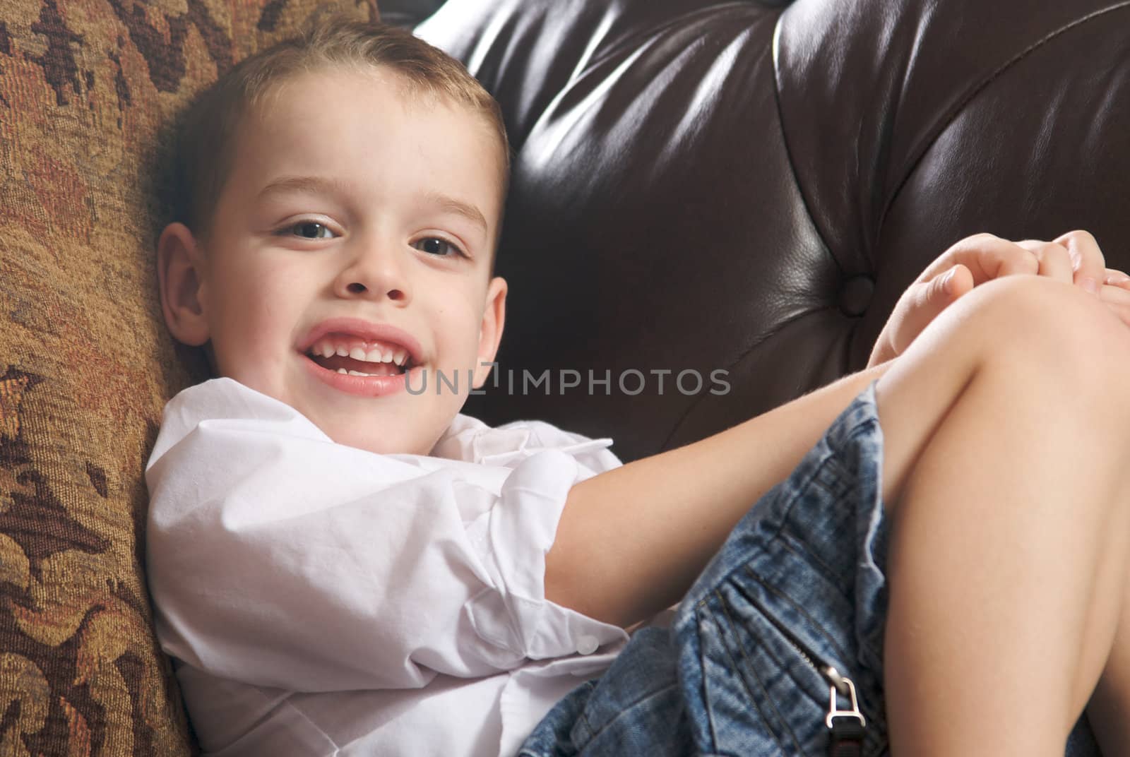 Adorable Young Boy with Blue Eyes Smiles for the Camera