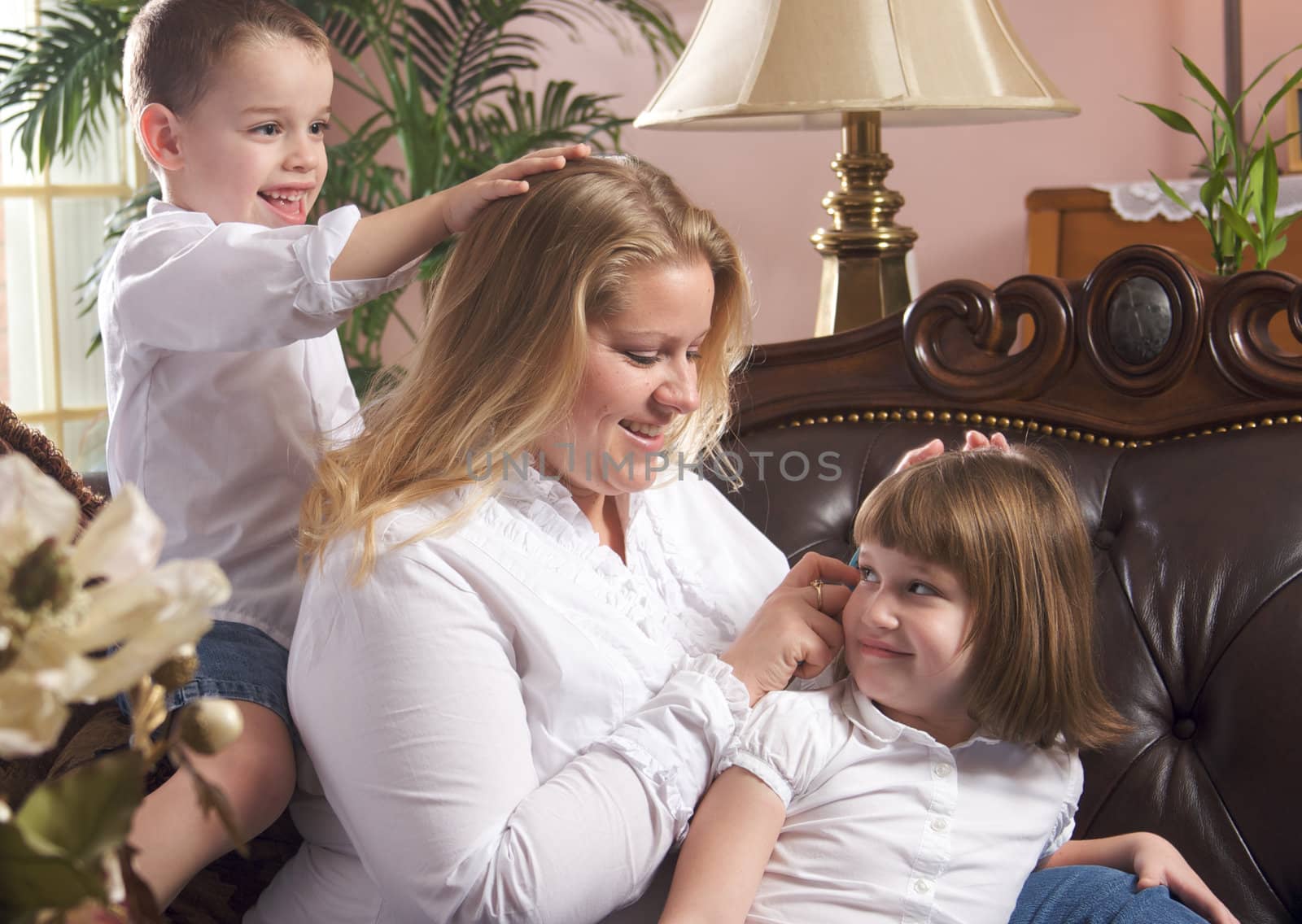 Mother and Children Enjoying a Fun Moment on the Couch