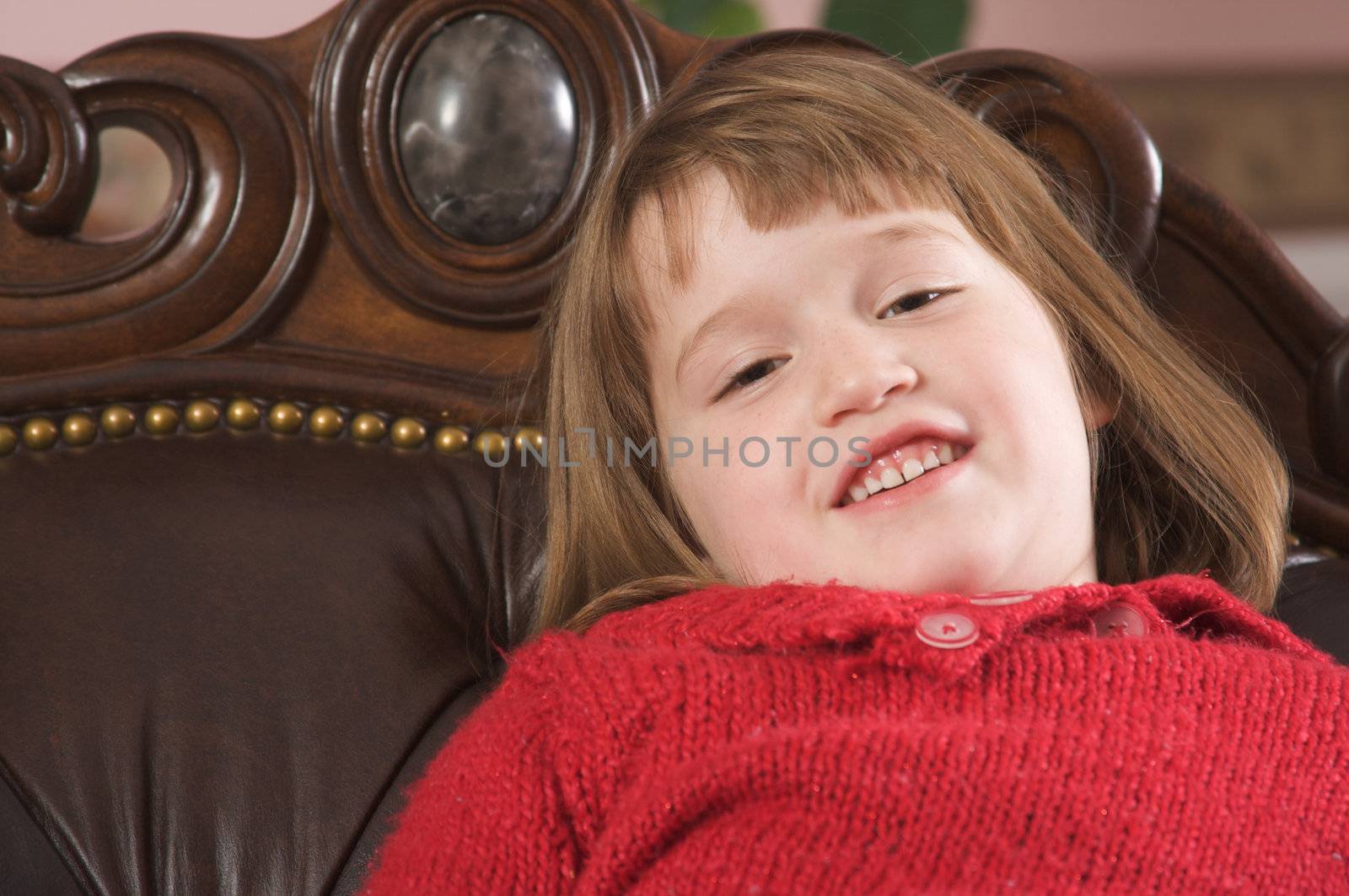 Adorable Girl Poses for a Fun Portrait on a Leather Chair
