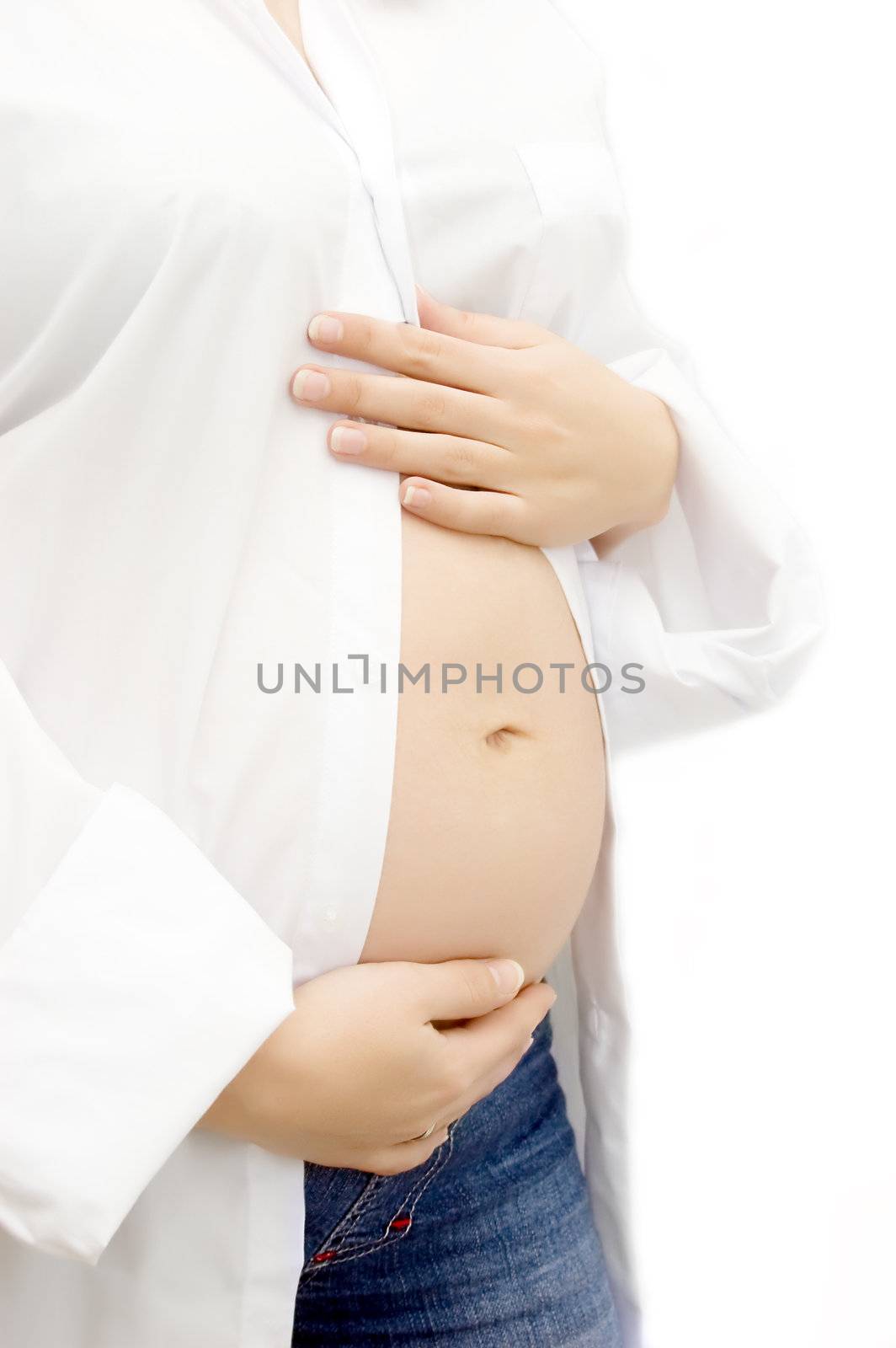 Woman hands holding pregnant belly over white