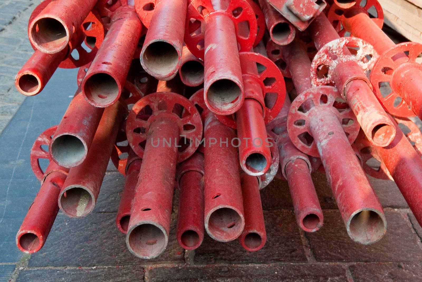 Red pipes on Bruges sidewalk