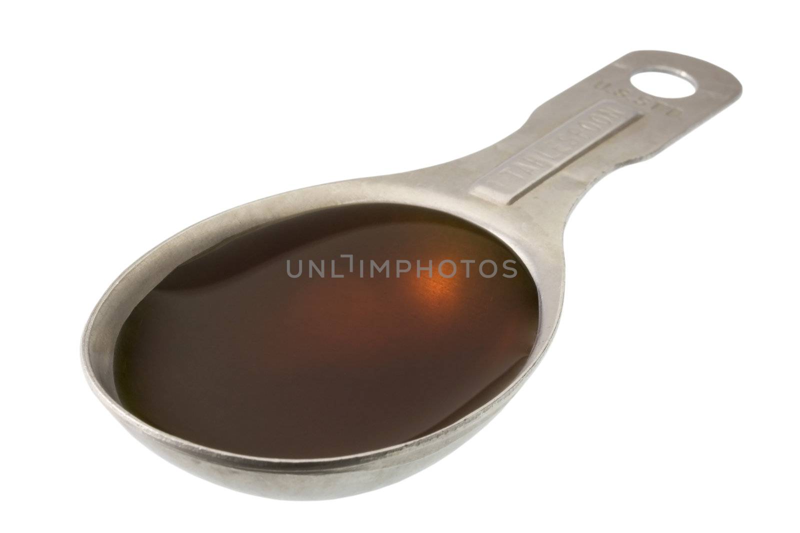 maple syrup on measuring, aluminum spoon isolated with clipping path