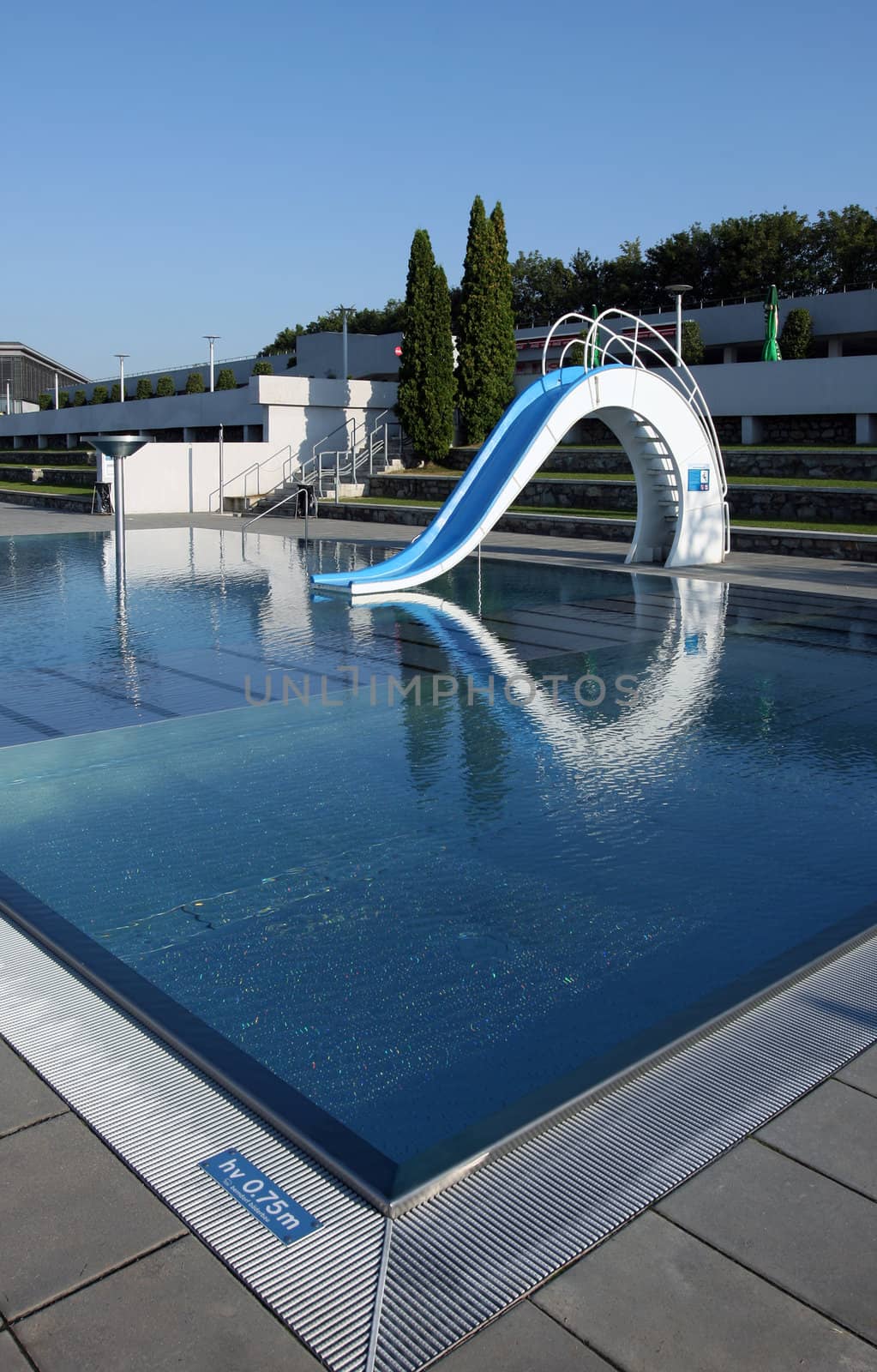 Dispeopled bath pool with white slide