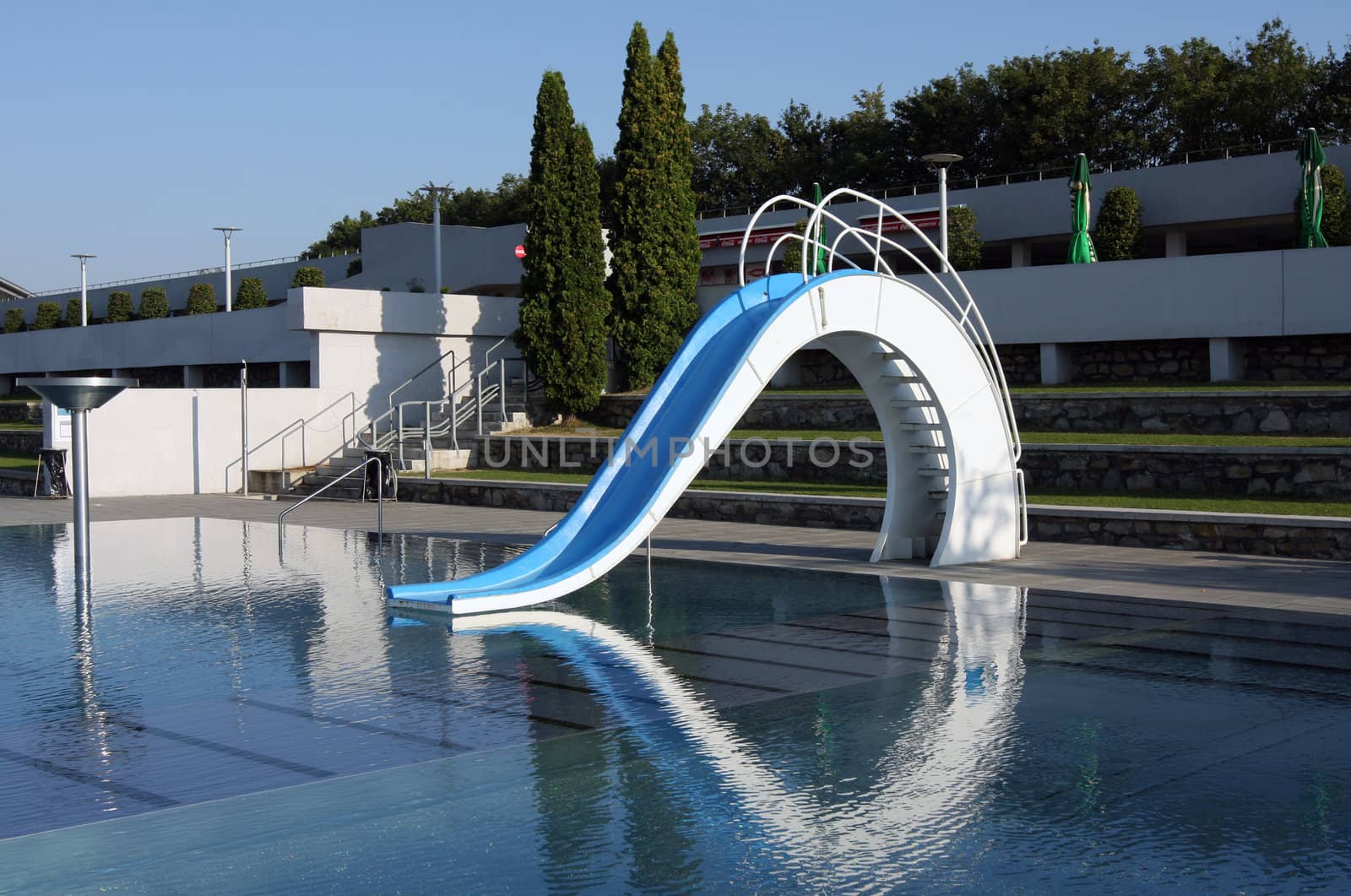 Dispeopled bath pool with white slide