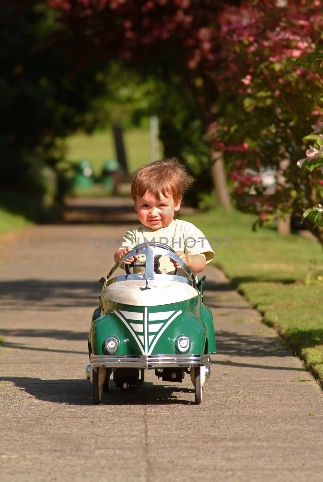 boy driving pedal car