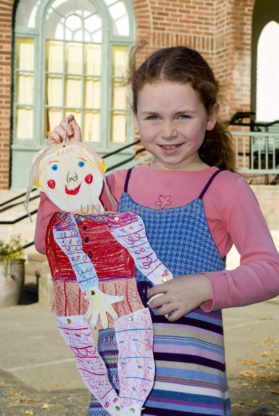 girl holding school art project