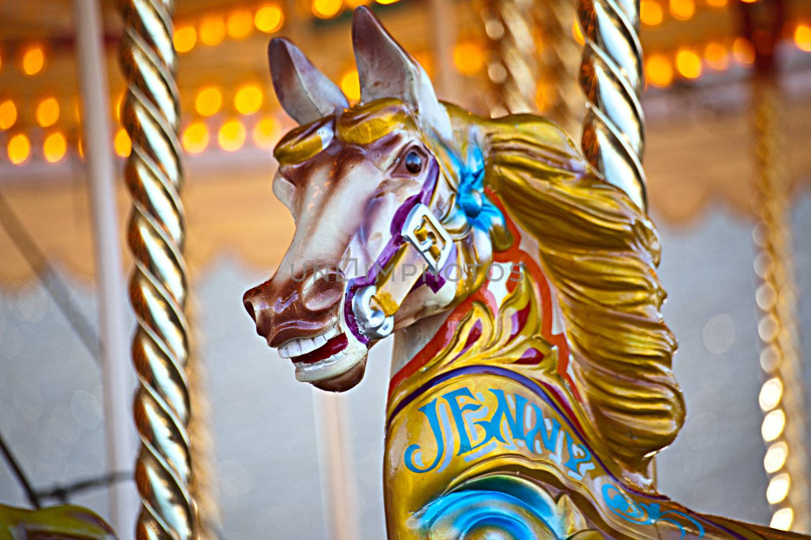 A colorful wooden horse on a carousel ride