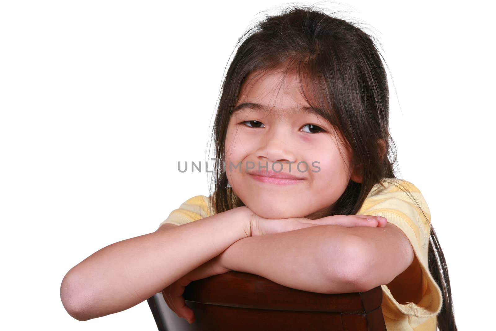 Beautiful little girl sitting on chair smiling, part Asian - Scandinavian descent