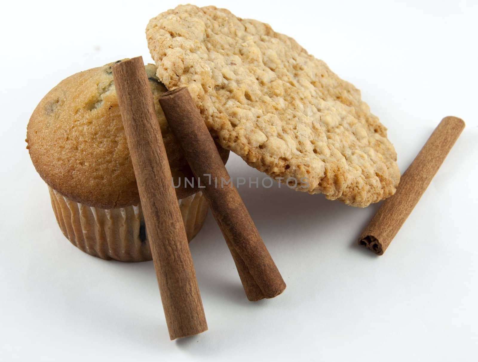 A blueberry muffin, and oatmeal cookie and cinnamon sticks.