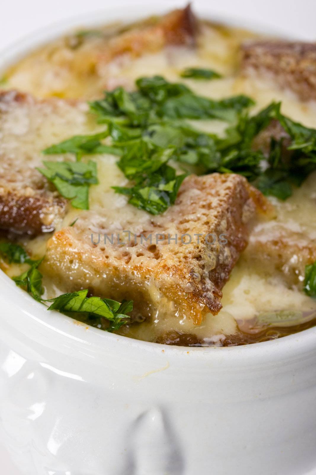 onion soup scalloped with cheese in a soup pot by bernjuer