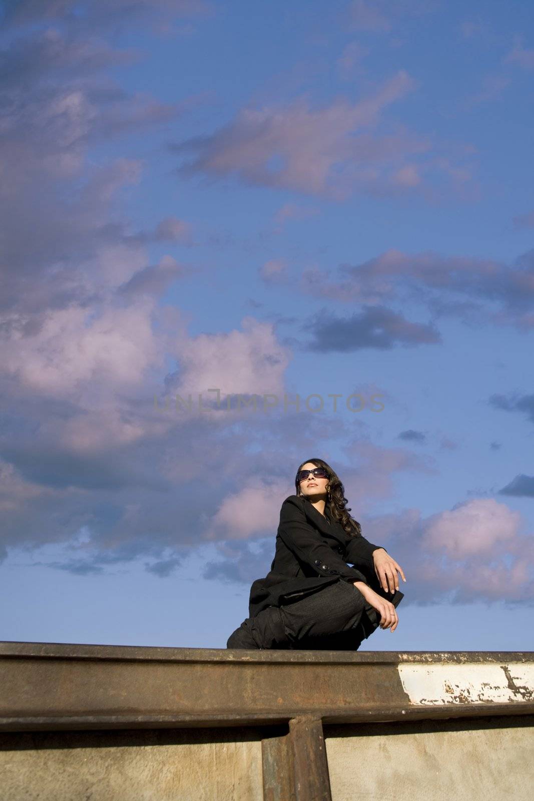 Pretty Hispanic woman with dark sunglasses in an urban setting