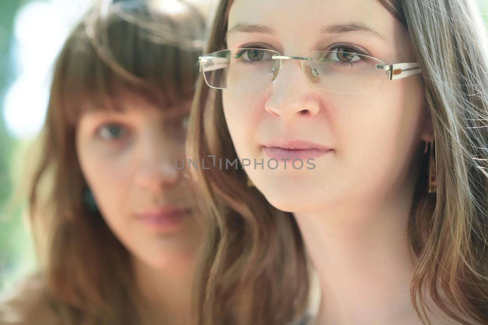 close-up portrait of the two young and beautiful girls