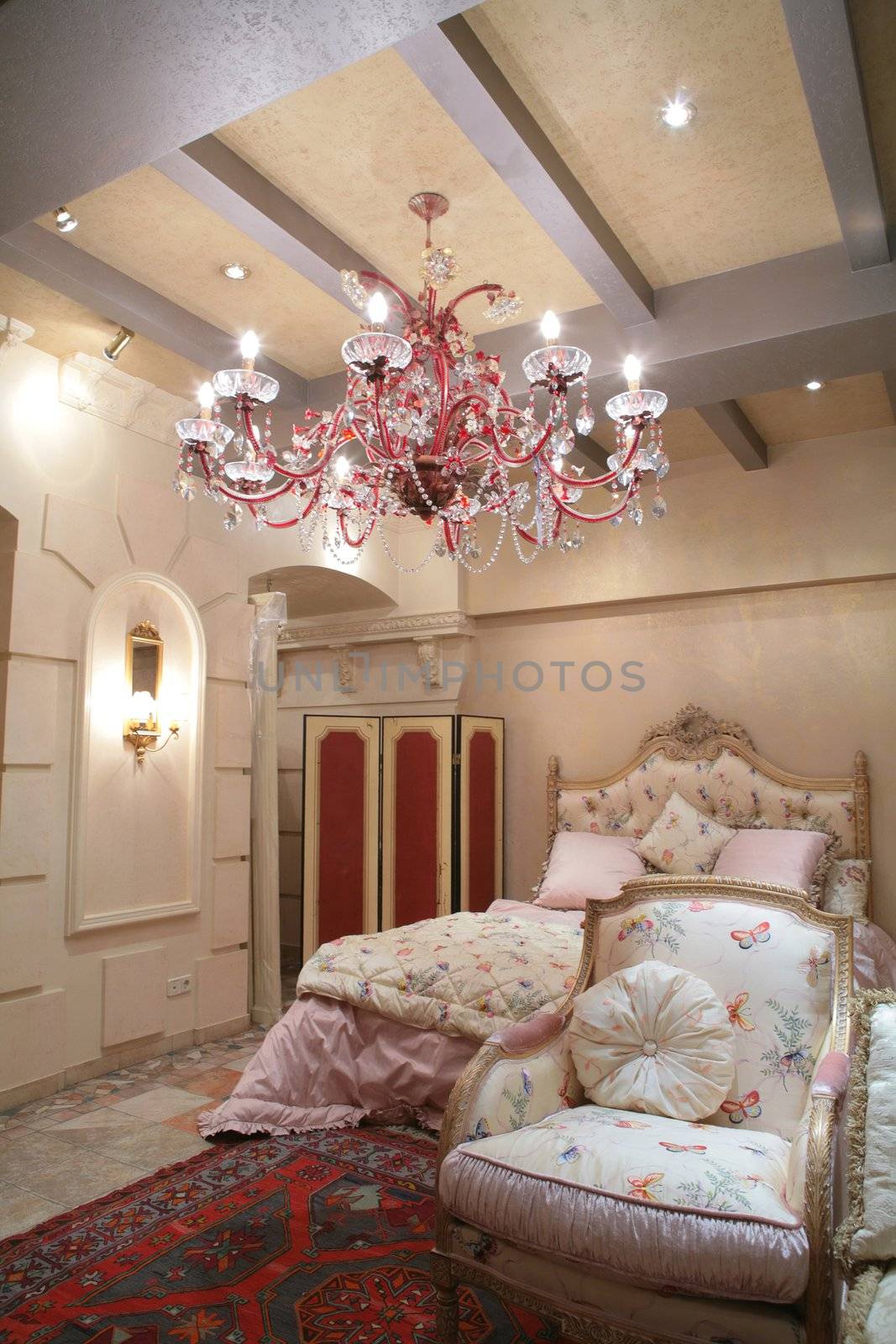 Interior to luxurious bedroom in rococo style, expensive furniture