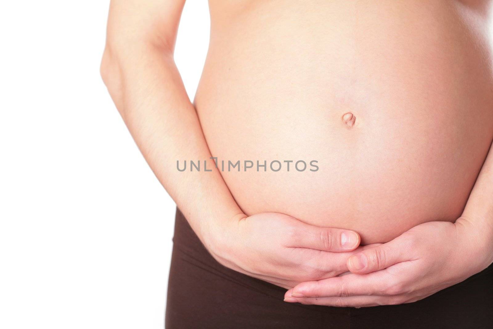 close-up, belly and hands of the pregnant woman on white background