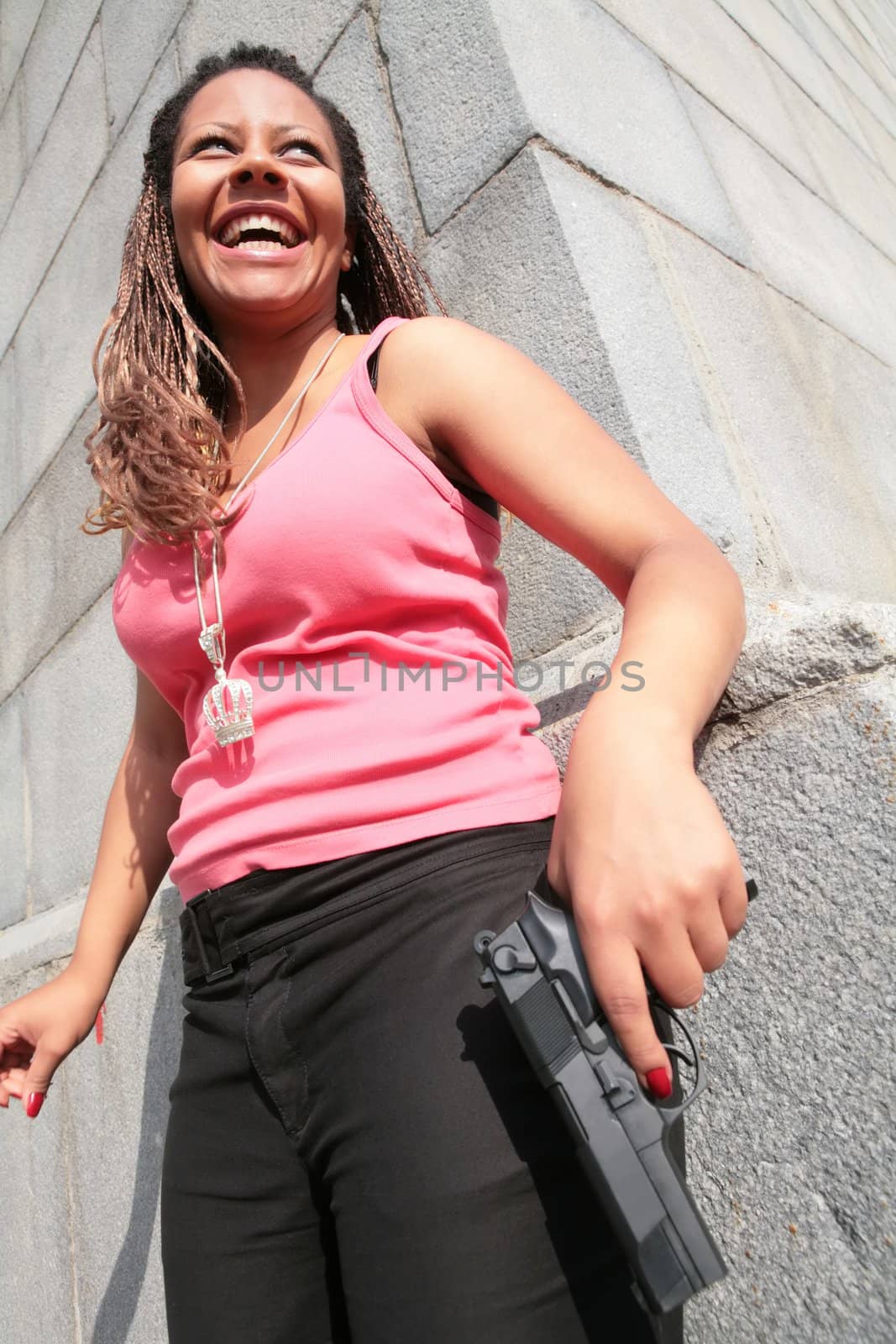 laughing gangster-woman in rose tanktop with big black gun