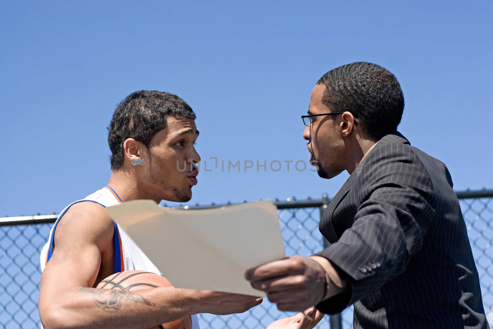 A young basketball player getting yelled at by his coach.