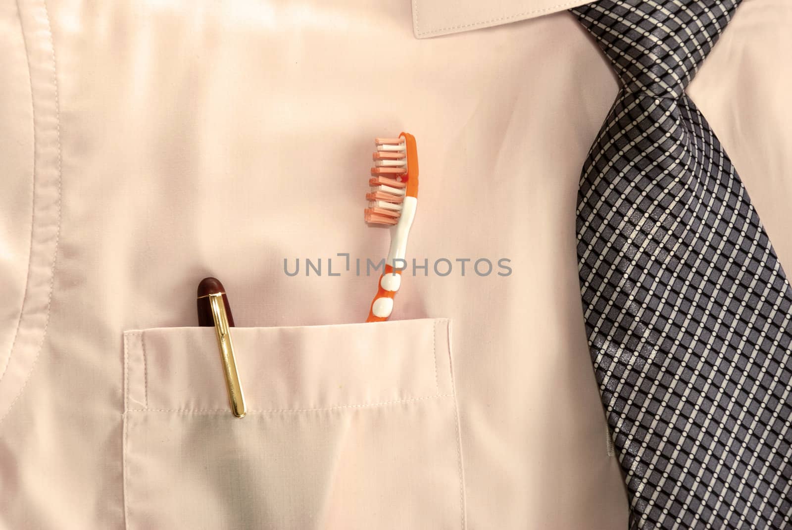 pen and tooth brush in business mans pocket
