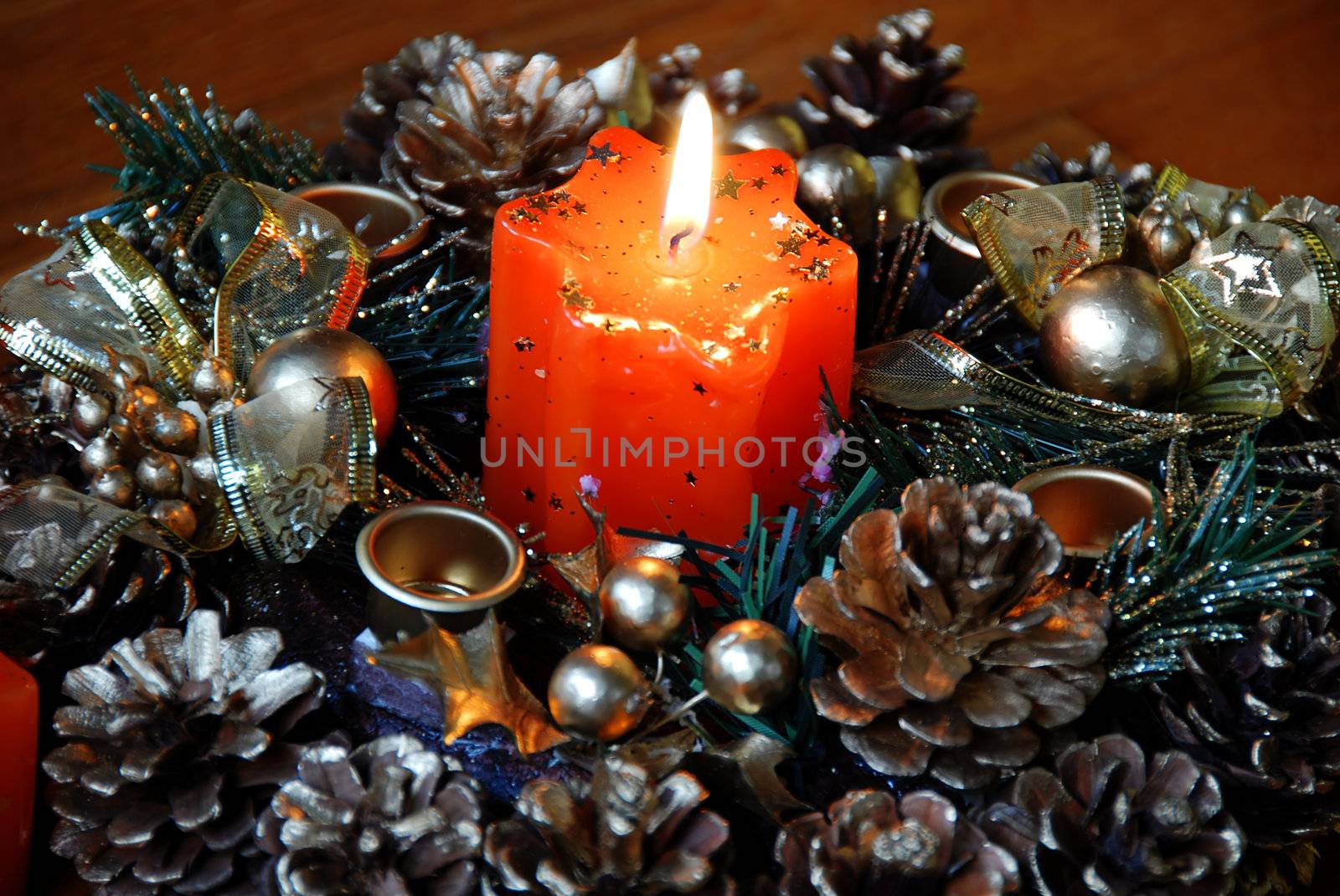 burning orange star shape candle over new year decoration