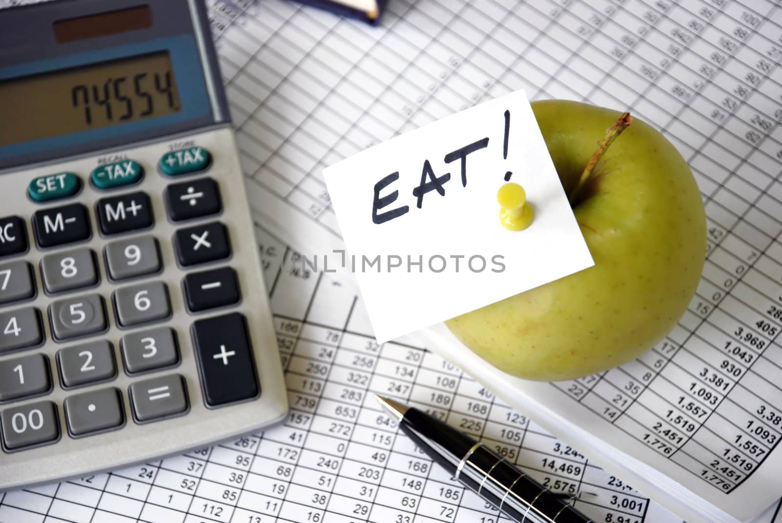 eat reminder on apple among papers and calculator