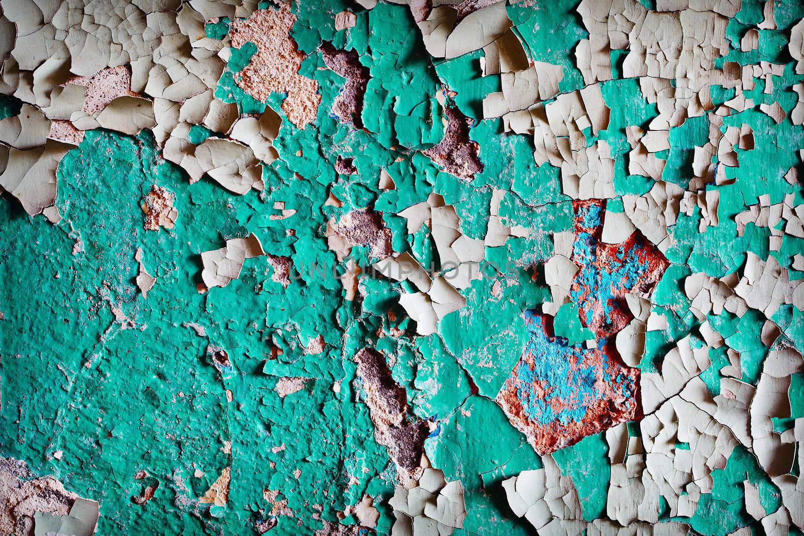 Background - the surface of the wall with several layers of weathered old paint