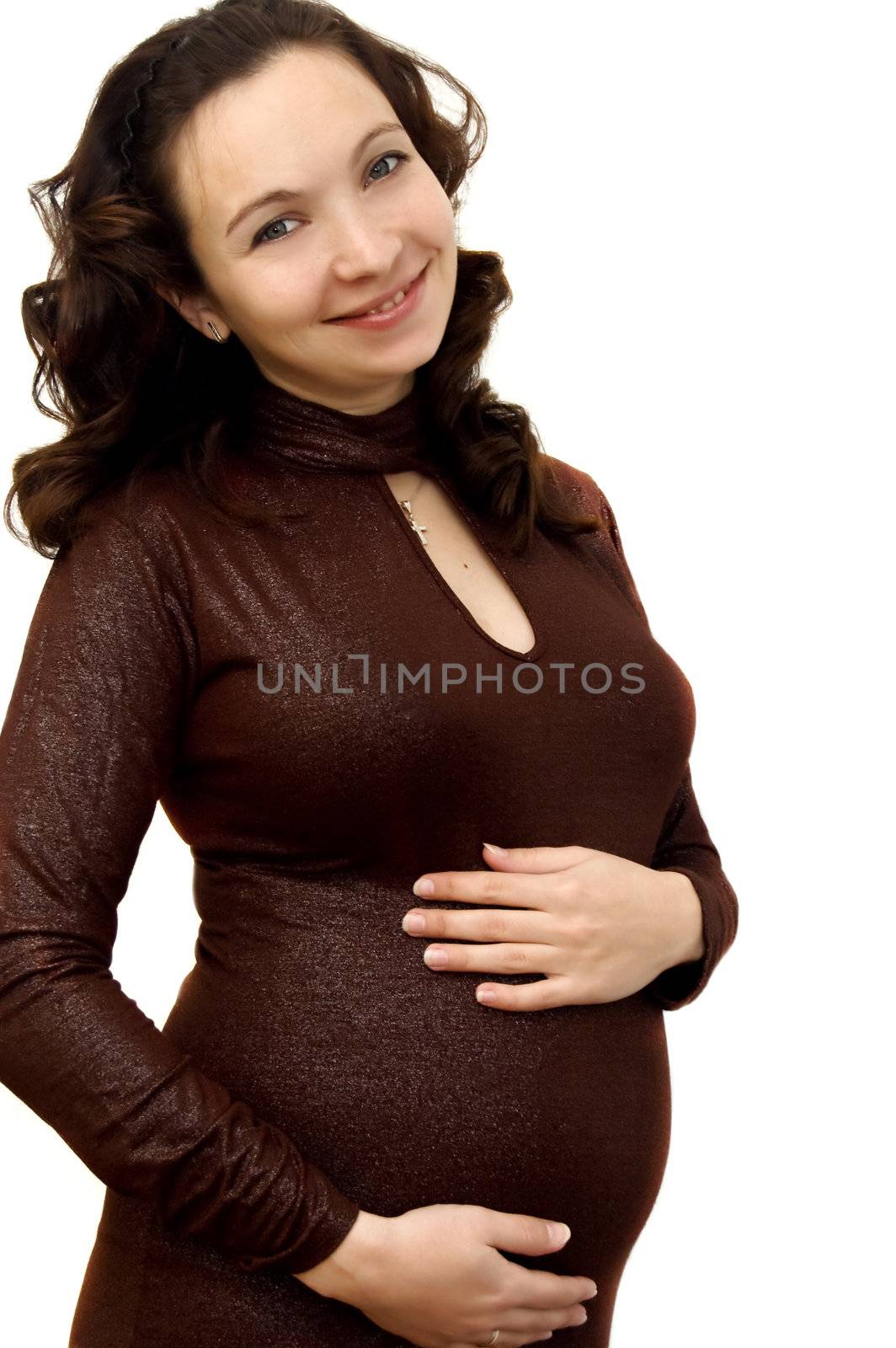 Smiling pregnant woman in elegant dress over white