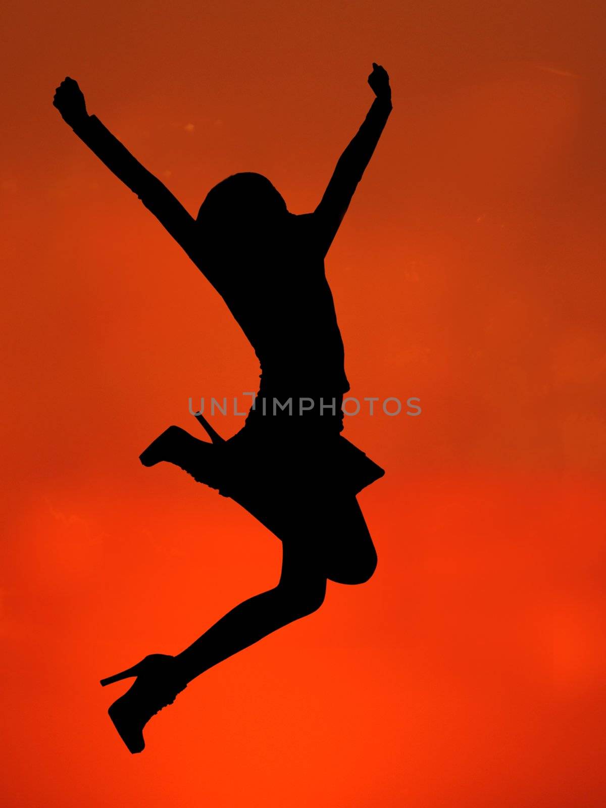 silhouette of a happy woman jumping