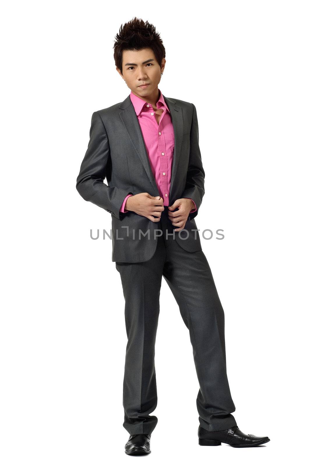 Full length portrait of young fashion business man isolated on white background.