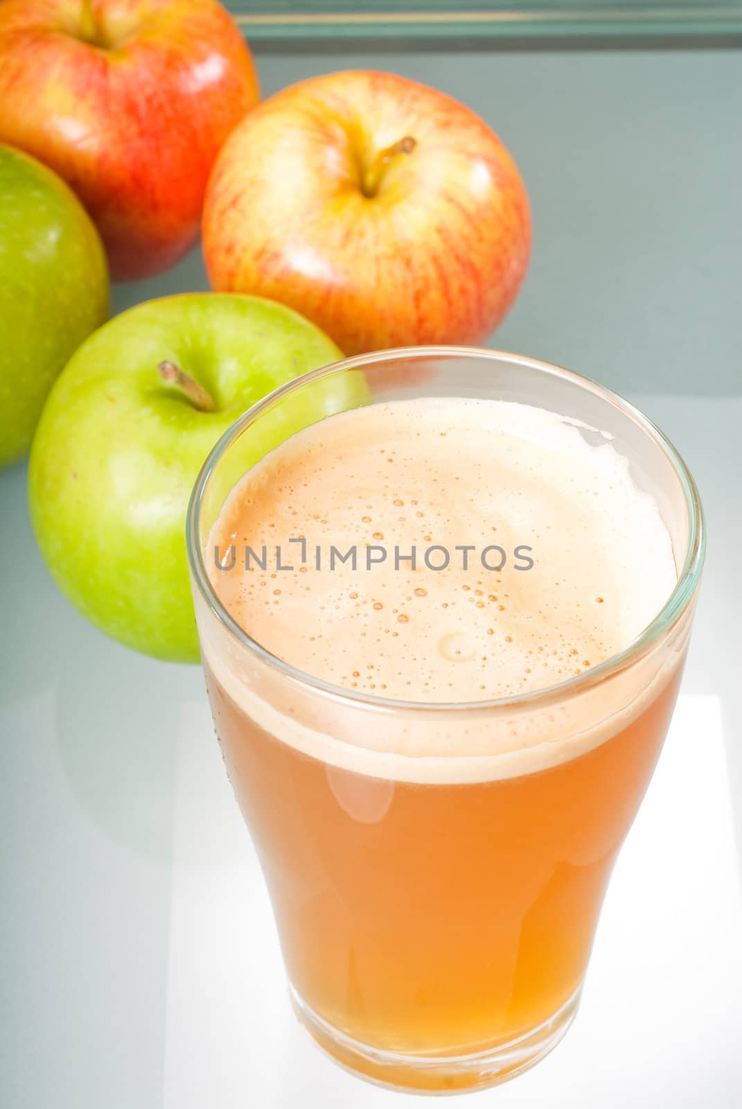 fresh  and healty natural apple  juice unfiltered , backlit on a light table