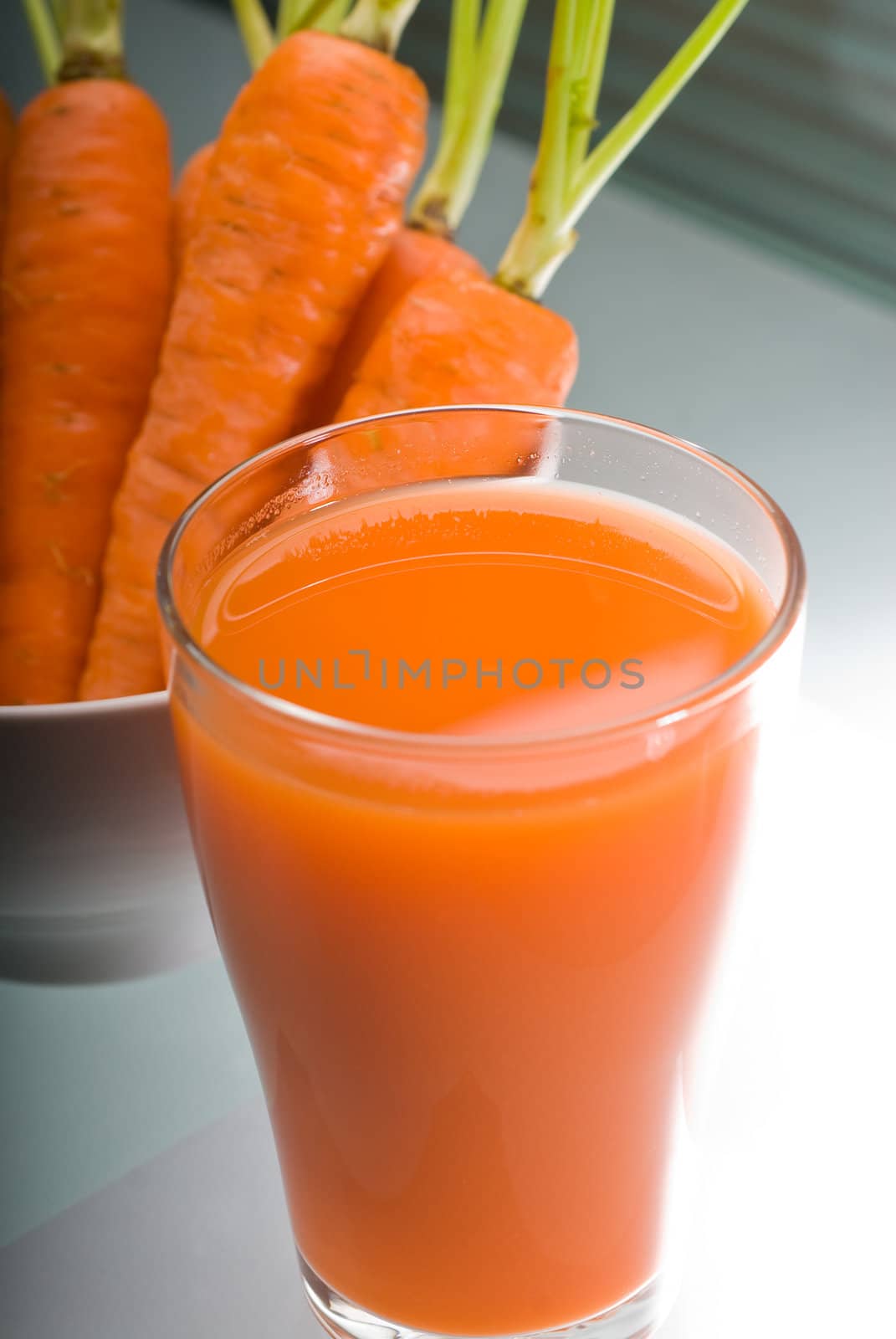 fresh and healty carrot juice unfiltered over a light table