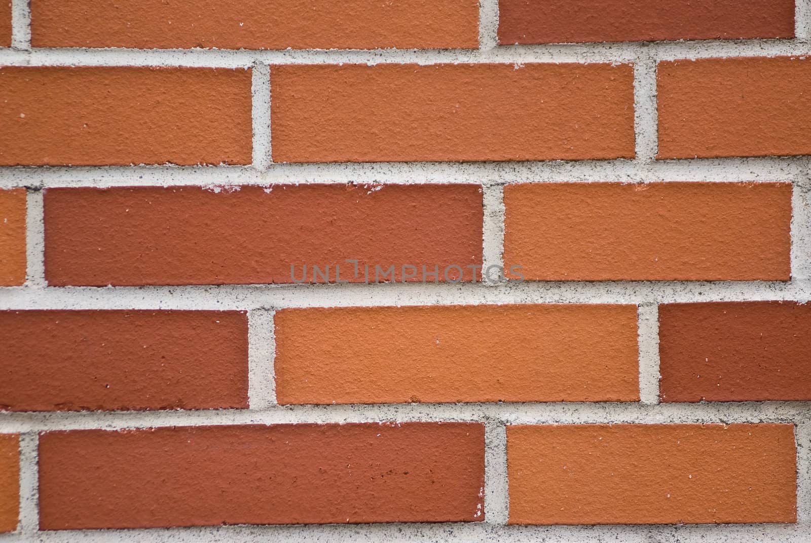 a brickwall with stones in shades of red and orange