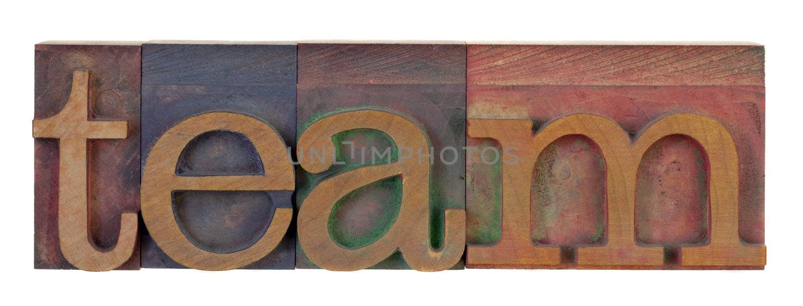 the word lteam in vintage wooden letterpress type blocks, stained by color ink, isolated on white