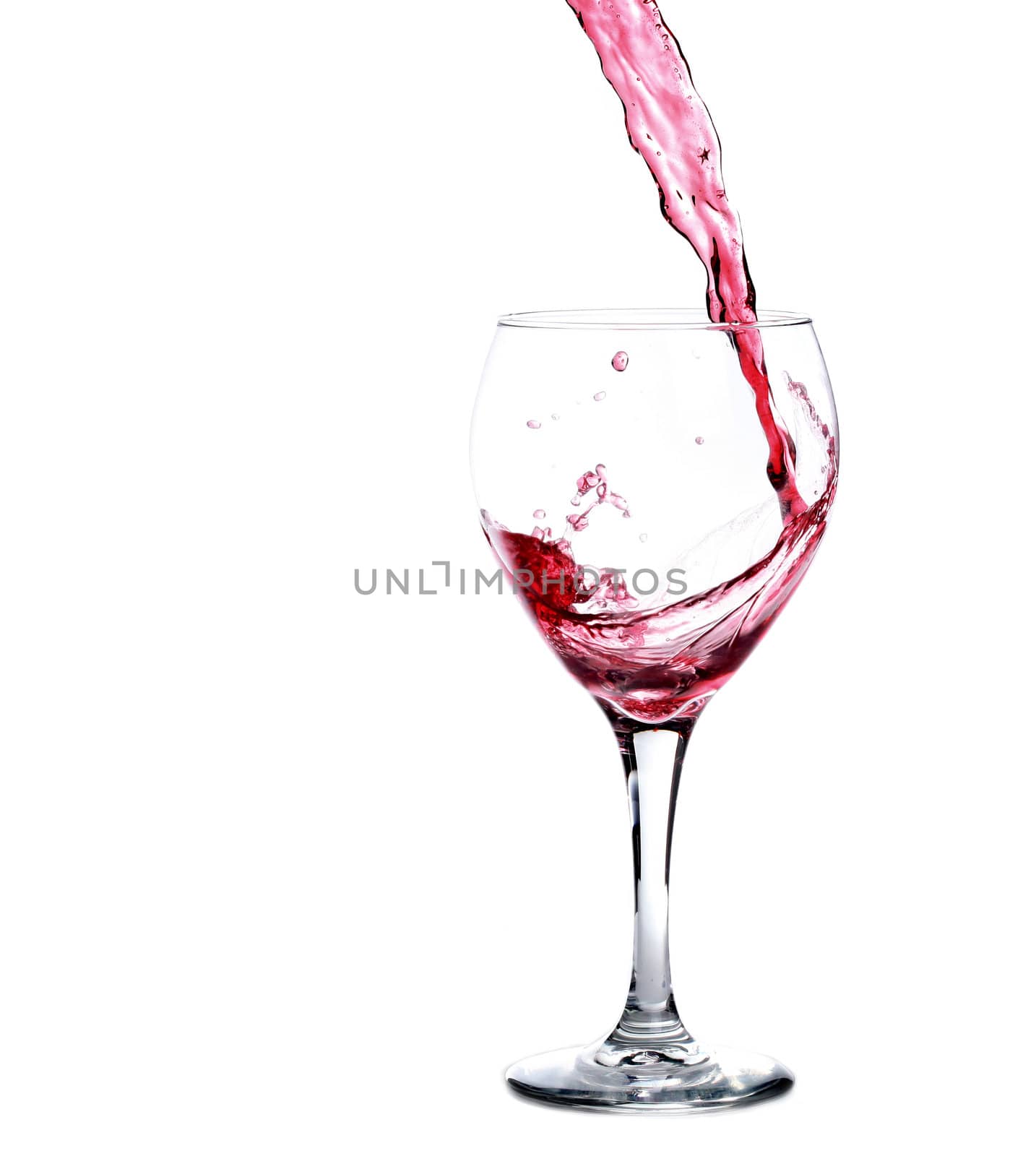 Glass of Red Merlot Wine Splashing While Being Poured