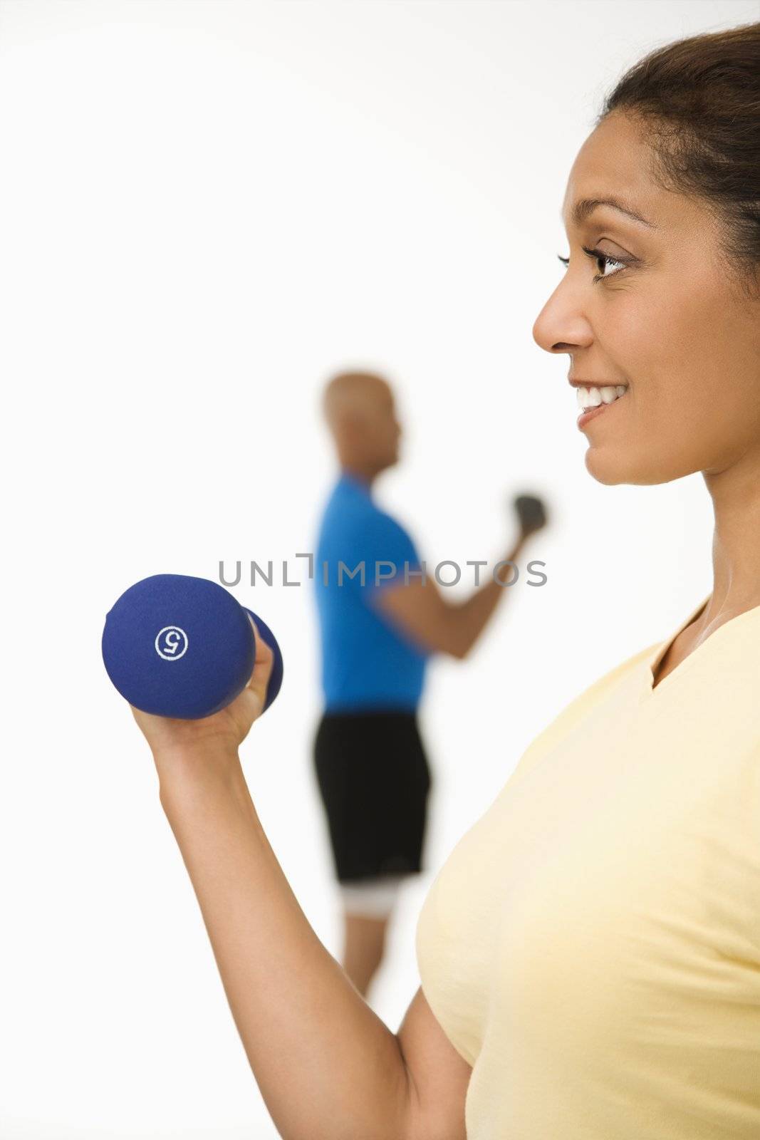 Woman exercising with dumbbell. by iofoto