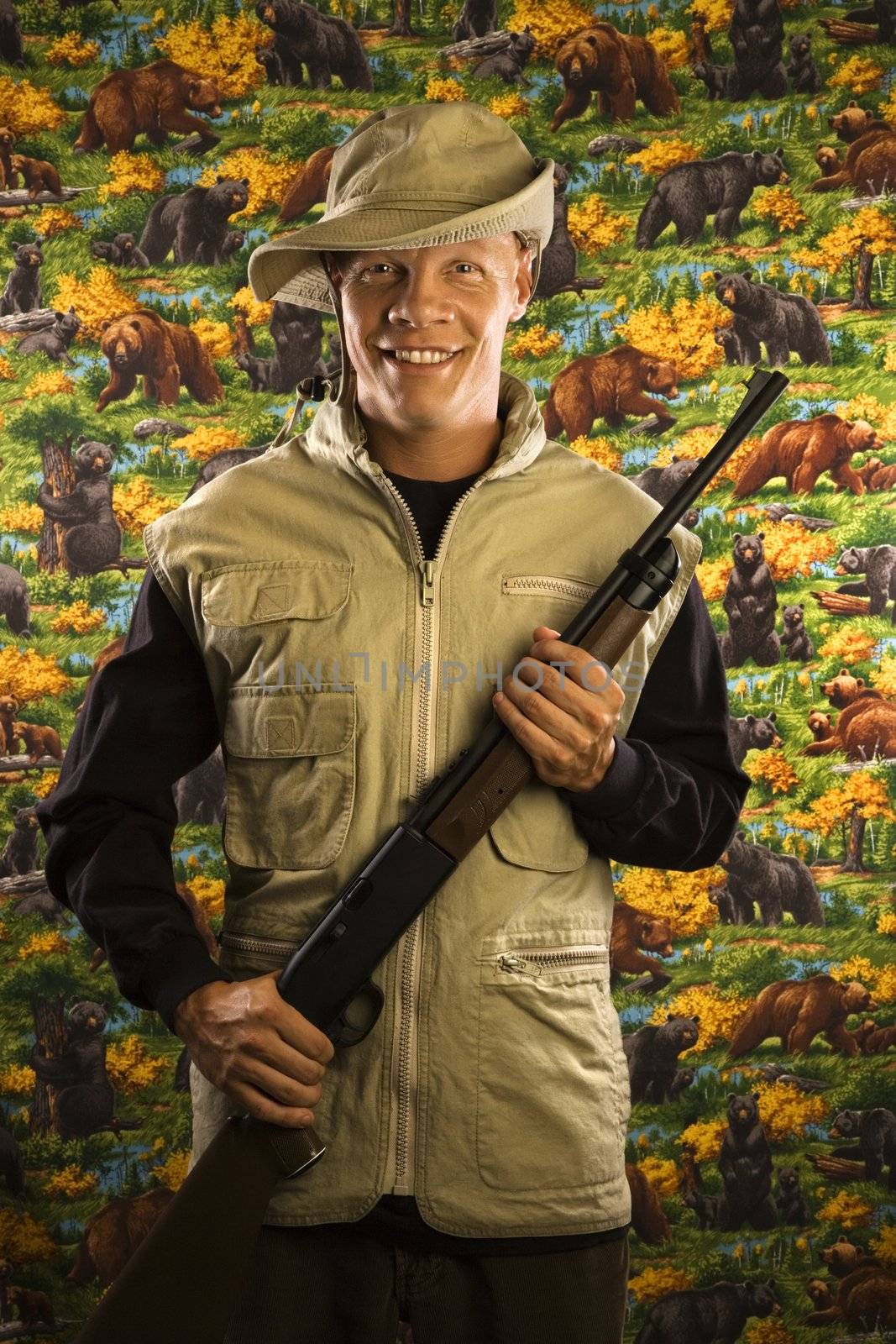 Mid-adult Caucasian male holding a rifle.