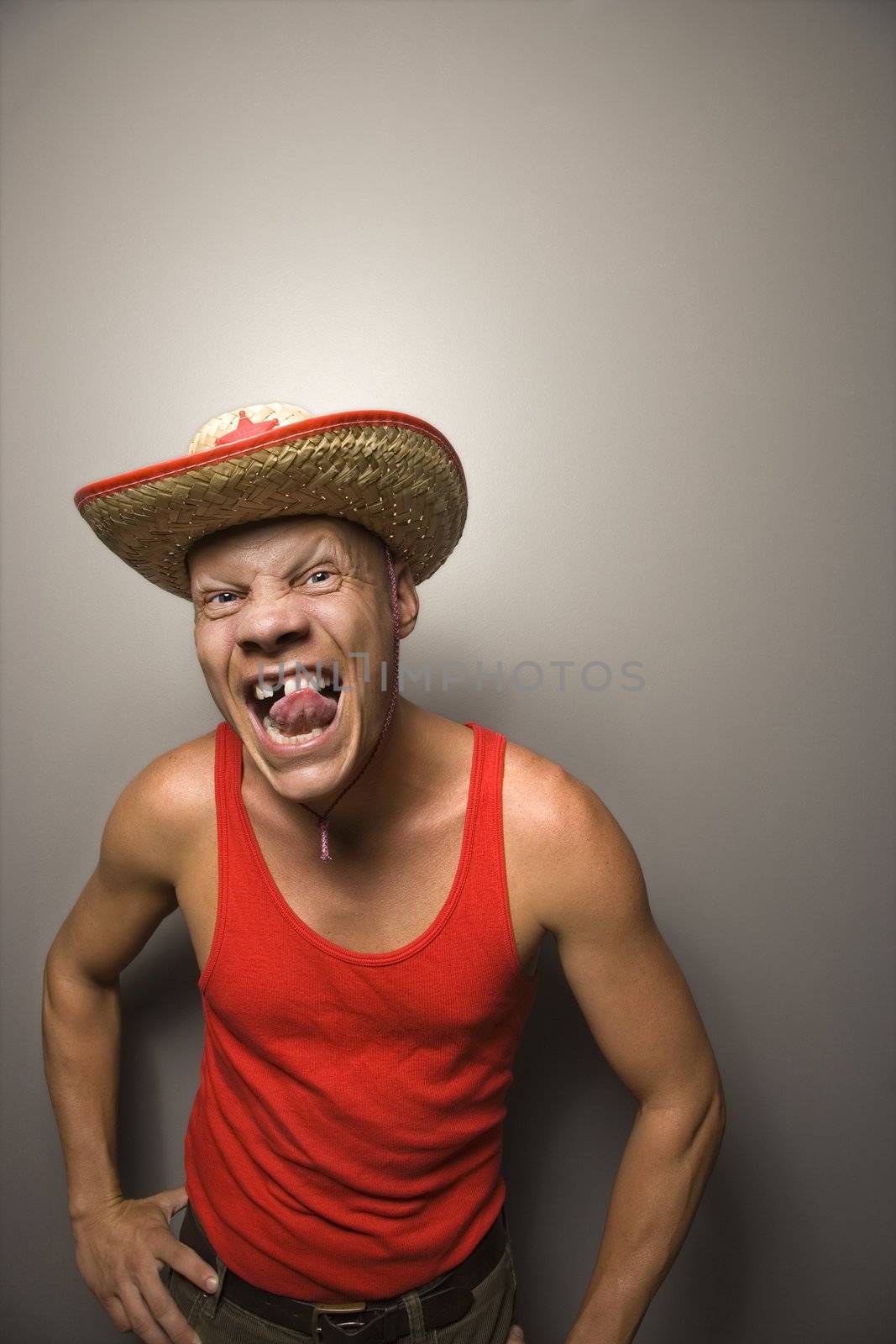 Portrait of a Mid-adult Caucasian male wearing straw hat with funny expression.