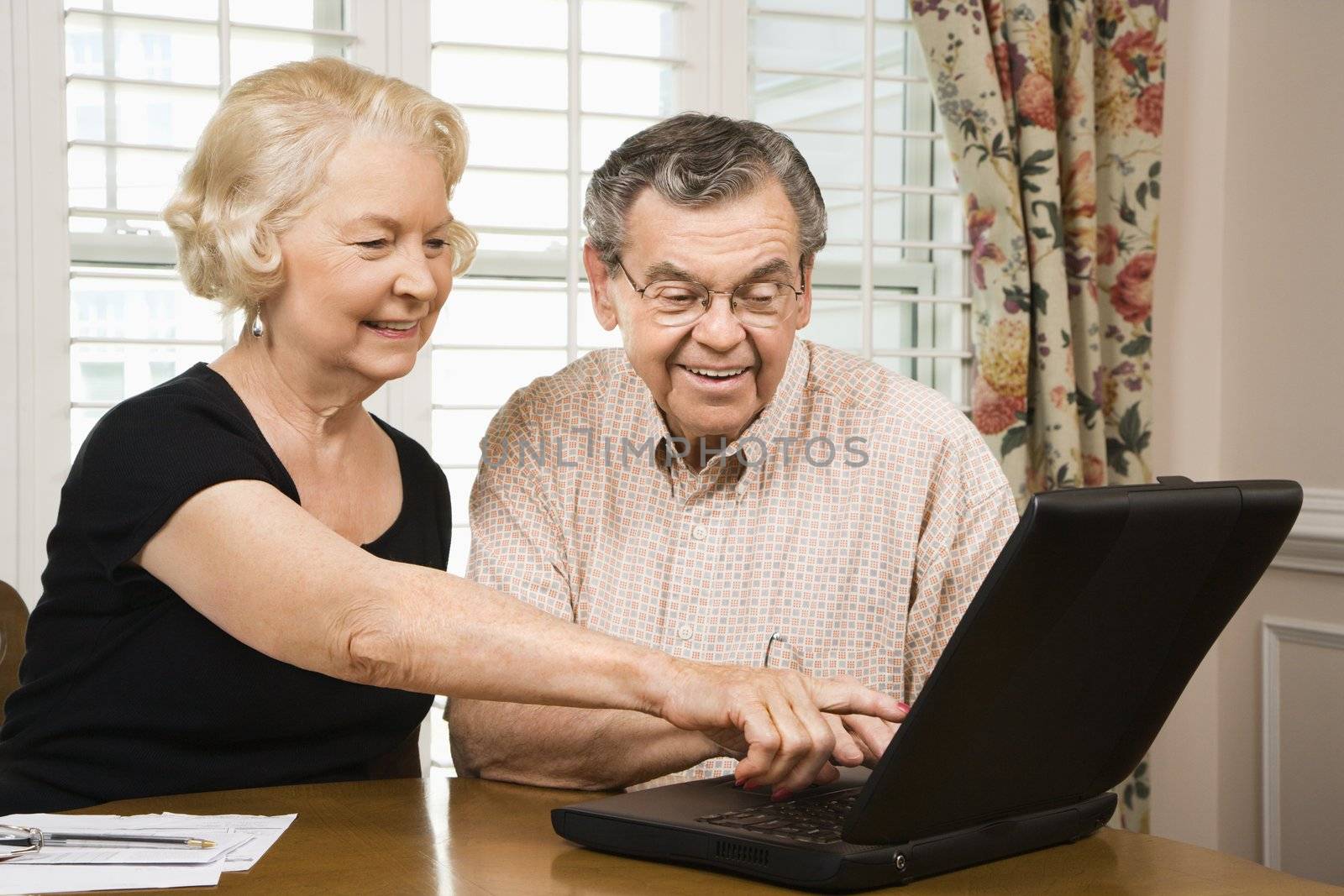 Mature couple with laptop. by iofoto