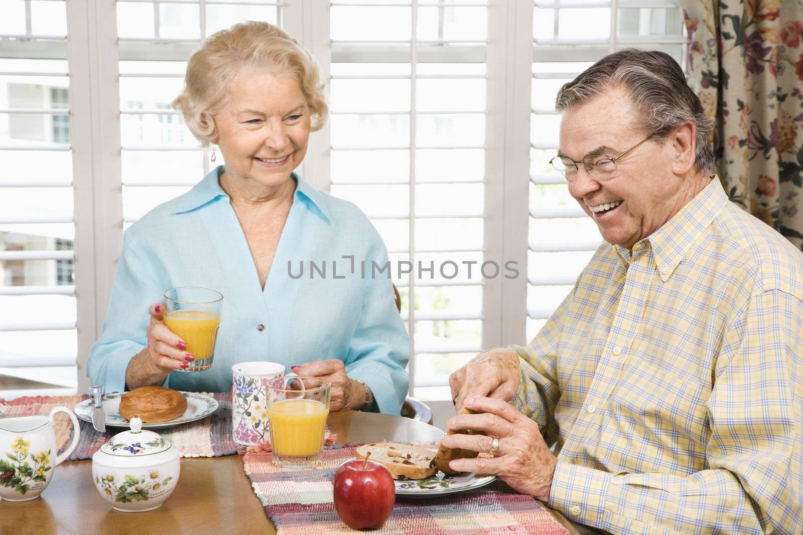 Mature Caucasian couple having breakfast together.