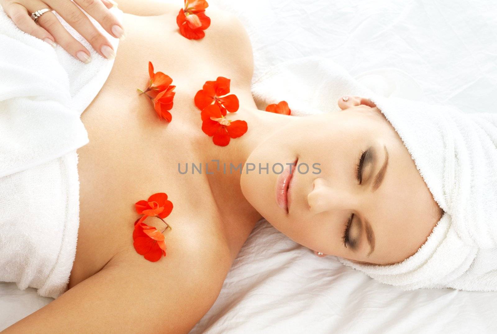 beautiful lady with red flower in spa